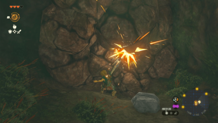 岩をハンマーで壊す