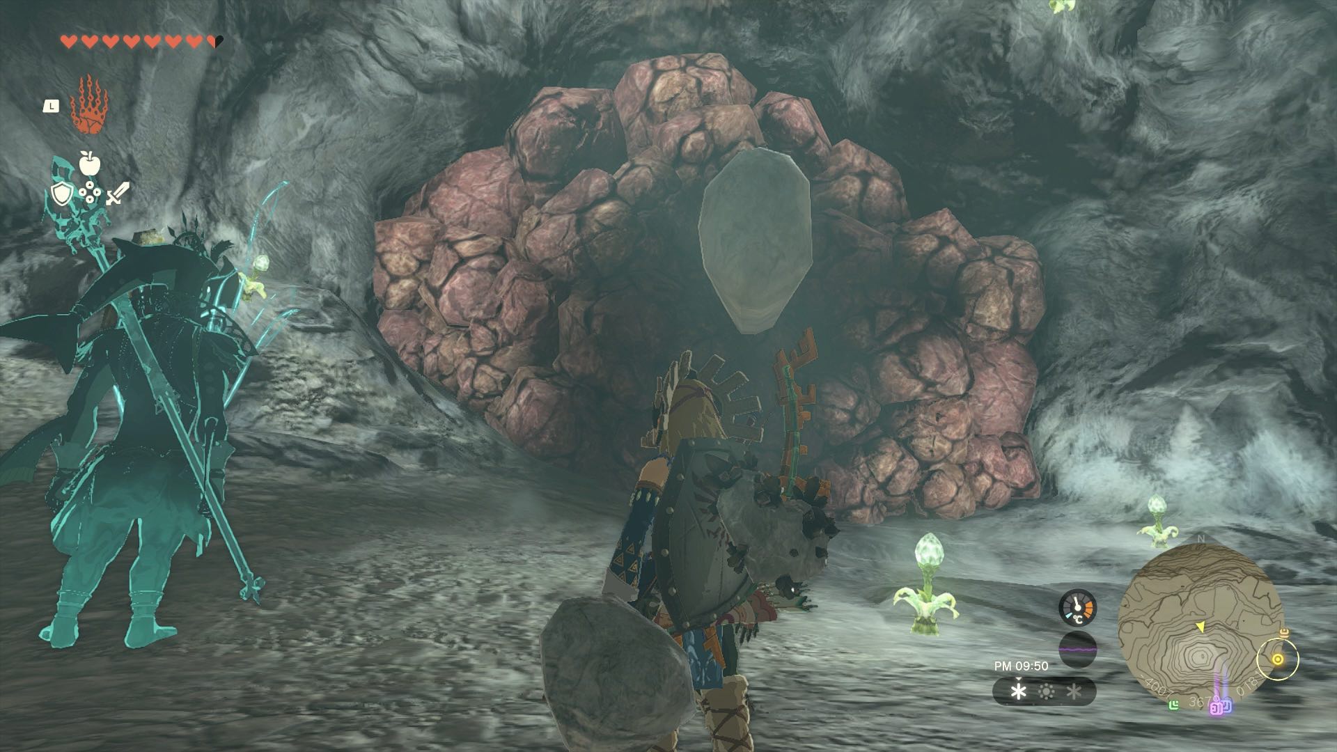 岩壁に埋まっている指の骨を岩ハンマーやバクダンで壊して取り出す