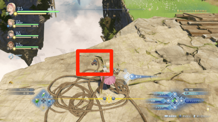 拘束されている島民達の間にある大きな岩場の上